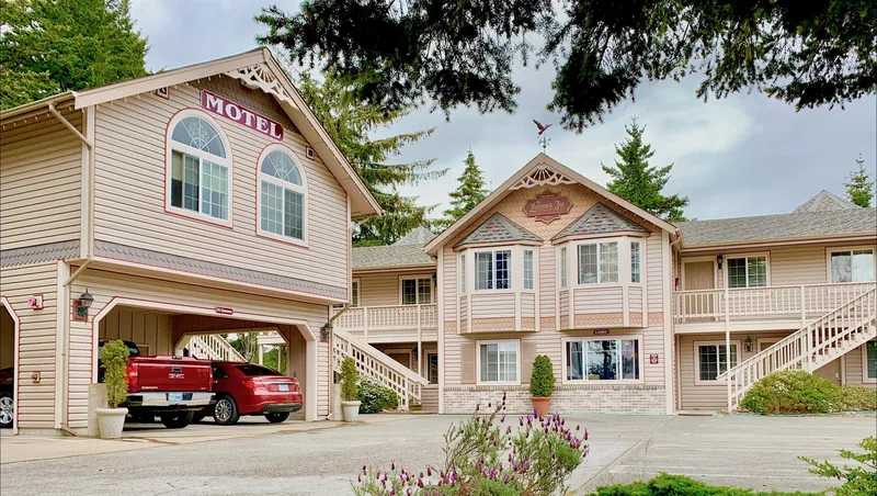 The Landmark Motel exterior among trees on its private hilltop in Florence, Oregon